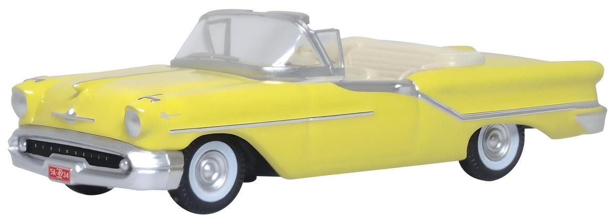 Oxford Diecast 87OC57001 1957 Oldsmobile 88 Convertible in Coronado Yellow with roof down, 1:87 scale model, front three-quarter view.