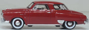 Oxford Diecast 87SC50003 1950 Studebaker Champion Starlight Coupe in Commanche Red, 1:87 scale model, left side view.