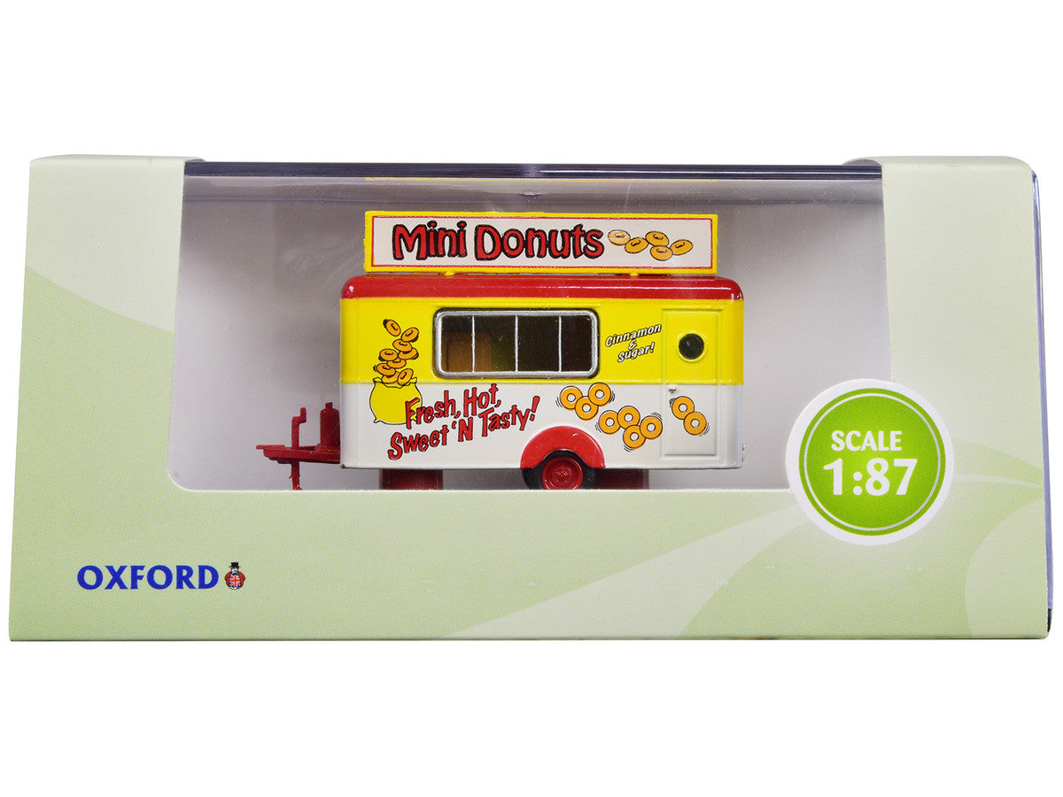 Oxford Diecast 87TR019 Mini Donuts mobile food trailer in yellow, white and red, 1:87 scale, shown in retail display packaging
