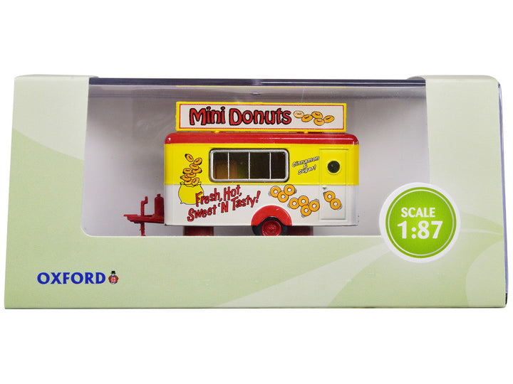 Oxford Diecast 87TR019 Mini Donuts mobile food trailer in yellow, white and red, 1:87 scale, shown in retail display packaging