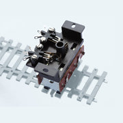 PECO PL-15 twin microswitch fitted to a turnout motor in a manufacturer installation example; motor and track not included