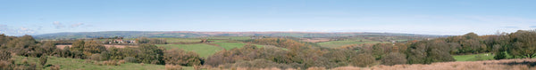 PECO SK-P04 Countryside photographic backscene showing fields, hedgerows, trees and distant hills beneath a blue sky.