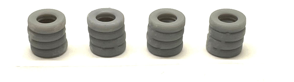 Four unpainted Phoenix Precision Models 30540 N-scale tire stacks