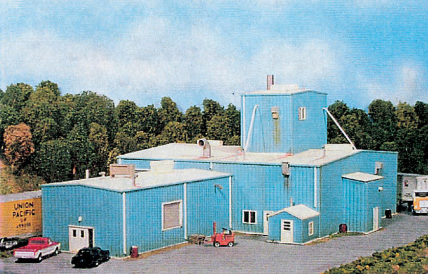 Pikestuff 541-0104 HO Milton A. Corporation industrial building kit shown assembled in a model railroad scene