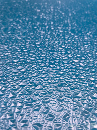 Rock Island Hobby 024441 clear Choppy Water plastic sheets, two-sheet pack, close-up of the clear water texture over a blue background.