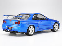 Tamiya 24258 1/24 Nissan Skyline GT-R V-spec II R34 model kit — assembled and painted blue rear three-quarter example with accessory wing