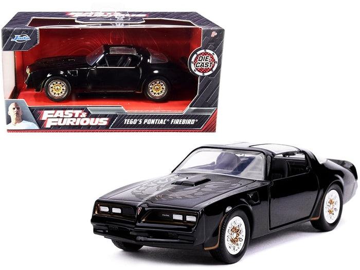 Black Pontiac Firebird model shown from the front three-quarter angle beside Fast & Furious packaging, Jada 30763