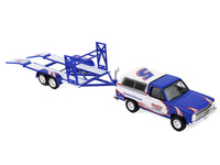 Angled view of the Hendrick K5 Blazer and empty blue tandem car trailer with raised center structure, GreenLight 1:64.