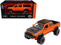 Orange and black 2023 Toyota Tacoma TRD Pro Harley-Davidson model shown with its Maisto HD Custom box.