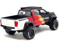 2023 Toyota Tacoma TRD Pro off-road pickup, matte black with graphics and roof rack, Maisto 1:27