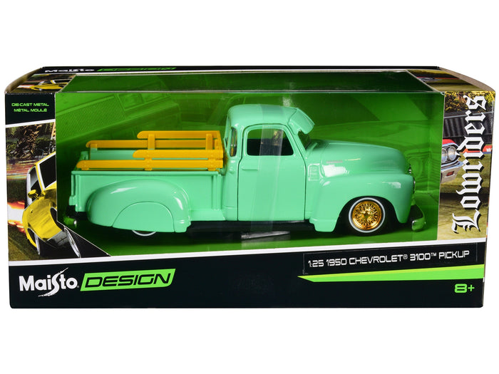 Light-green 1950 Chevrolet 3100 lowrider with gold wheels in Maisto Design packaging marked 1:25 scale.