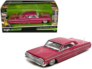 Maisto 1:26 1964 Chevrolet Impala SS lowrider in pink with graphics and white interior.