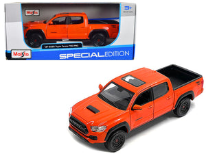 Maisto 1:27 2023 Toyota Tacoma TRD Pro pickup in Solar Octane orange with sunroof.