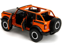 2021 Ford Bronco Open-Top Orange with Black Stripes and Hood with Extra Wheels "Just Trucks" Series 1/24 Diecast Model Car by Jada image 3