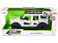 White 2021 Ford Bronco with red stripes and roof rack inside green Just Trucks window packaging, Jada 34286