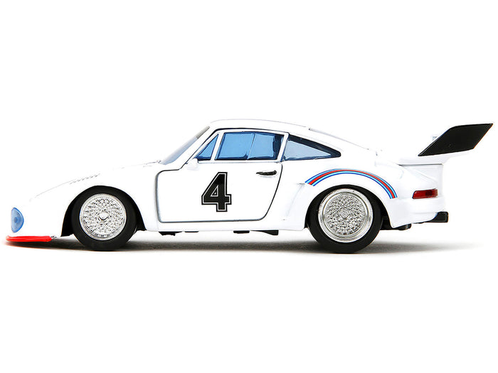 Side profile of white Porsche 935 Turbo number 4 with blue and red stripes, Transformers Jazz 1:32 model by Jada