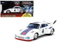 White number 4 Porsche 935 Turbo shown beside Transformers anniversary window packaging, Jada 34793 in 1:32