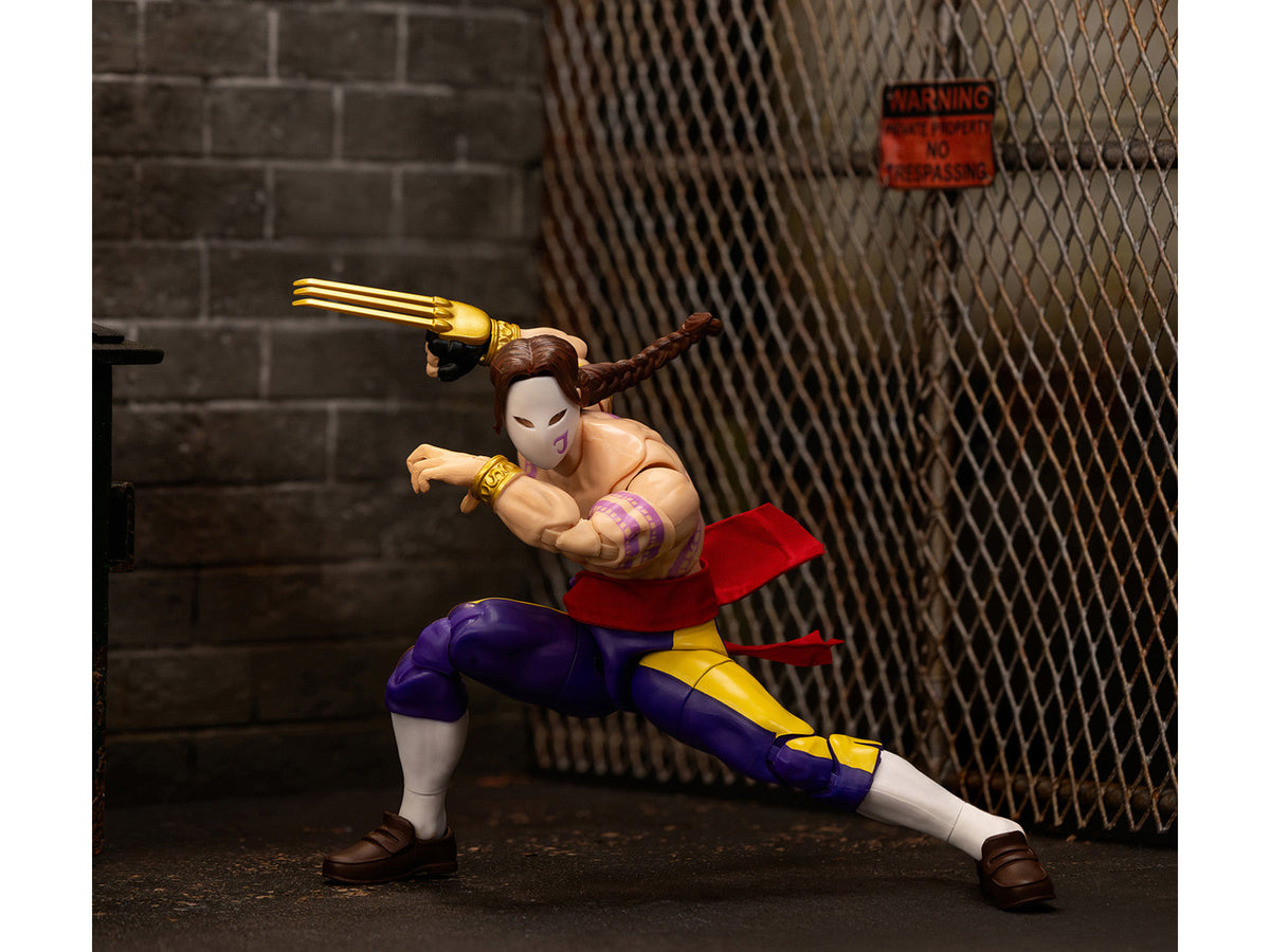 Jada 35172 Vega action figure posed lunging beside a chain-link fence and brick display backdrop