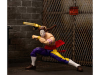 Jada 35172 Vega action figure posed lunging beside a chain-link fence and brick display backdrop