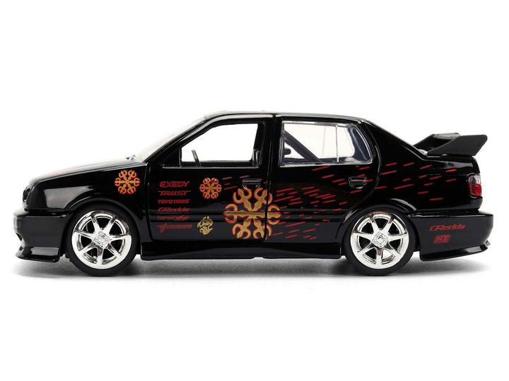 Black Volkswagen Jetta with orange graphics, Fast & Furious Remix, 1:32, closed side view — Jada 35628