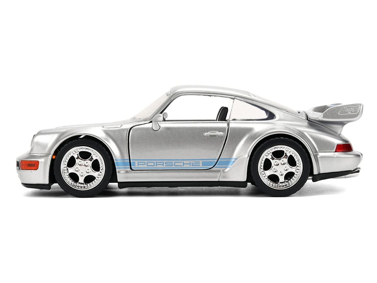 Silver Mirage Porsche 911 Carrera RS 3.8 with blue stripes, closed side view, Jada 36210, 1:32