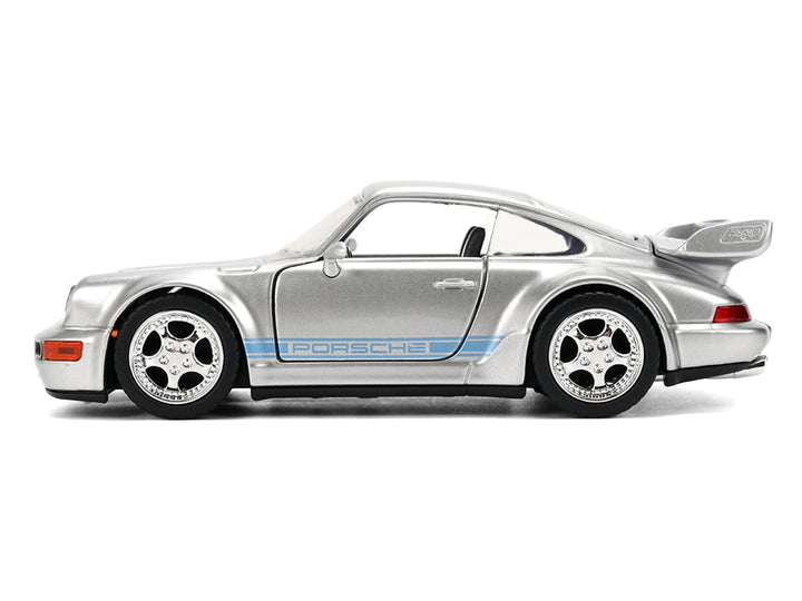 Silver Mirage Porsche 911 Carrera RS 3.8 with blue stripes, closed side view, Jada 36210, 1:32