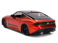 Rear three-quarter view of orange metallic Nissan Z with black roof and closed panels, Jada 37490