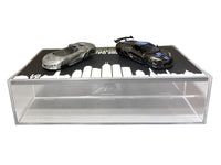 GreenLight 1:64 2025 Corvette C8 ZR1 black with blue details beside its raw casting on the display case, item 51683A.