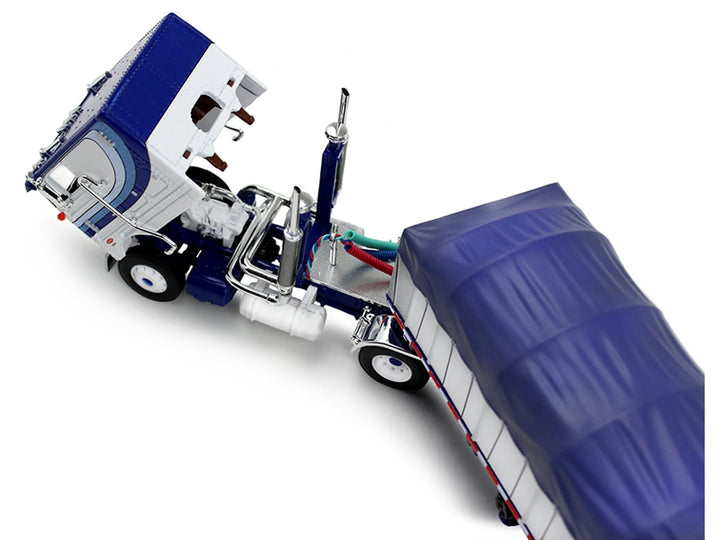 Peterbilt 352 COE 110" Sleeper and 53' Wilson Roadbrute Flatbed Trailer with Covered Wagon White with Blue Stripes 1/64 Diecast Model by DCP/First Gear image 2