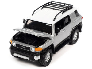 Johnny Lightning 2007 Toyota FJ Cruiser in Titanium Silver with white roof and roof rack.