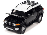 Johnny Lightning 2007 Toyota FJ Cruiser in Black Diamond with white roof and roof rack.