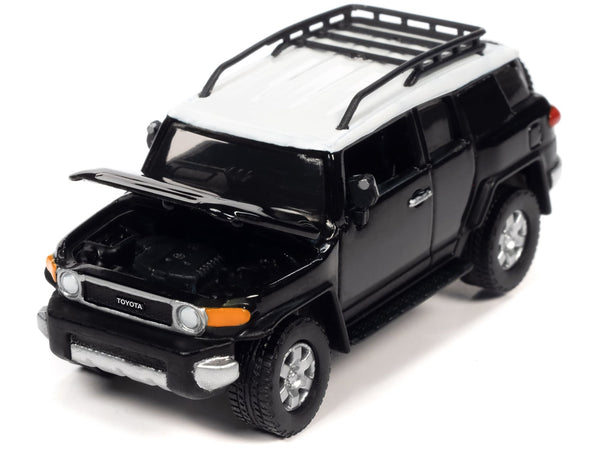 Johnny Lightning 2007 Toyota FJ Cruiser in Black Diamond with white roof and roof rack.