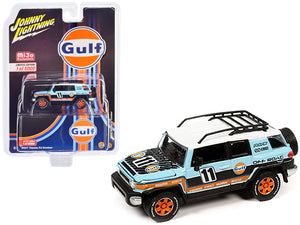 Johnny Lightning 2007 Toyota FJ Cruiser #11 in light-blue Gulf livery with roof rack.