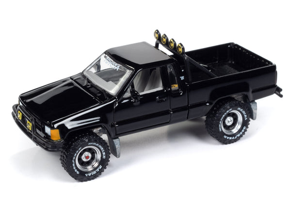 Johnny Lightning 1:64 black 1985 Toyota SR5 pickup, Mystery Matinee release, hood closed.