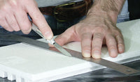 Woodland Scenics ST1433 Foam Knife cutting foam along a straightedge, manufacturer demonstration