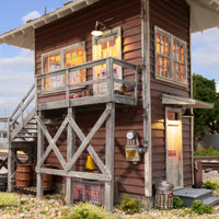 Woodland Scenics BR4964 Interlocking Tower, manufacturer close-up of illuminated doors and balcony.