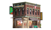 Woodland Scenics BR5024 Corner Emporium HO scale built-up building, front corner view with barber shop and tobacco storefronts.
