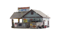 Woodland Scenics BR5048 Ethyl's Gas & Service HO scale Built-&-Ready model, side view with fence and vintage advertising.