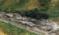 Woodland Scenics C1141 Creek Bed Ready Rocks, installed landscape example; surrounding scenery is separate.