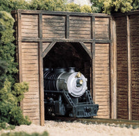 Woodland Scenics C1154 N scale timber single-track tunnel portals, painted portal in a railway layout; locomotive, track, retaining walls and scenery are separate.