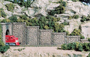 Woodland Scenics C1161 retaining walls painted and arranged on a model railway; train, tunnel portal and scenery are separate.
