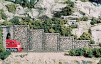 Woodland Scenics C1161 retaining walls painted and arranged on a model railway; train, tunnel portal and scenery are separate.