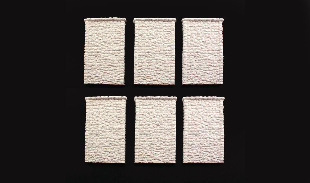 Woodland Scenics C1161 six unpainted random stone retaining-wall sections.