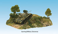 Woodland Scenics Shaper Sheet military terrain example; model tank, trees and scenery are separate.