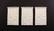 Woodland Scenics C1261 HO scale random-stone retaining walls, three unpainted wall sections.