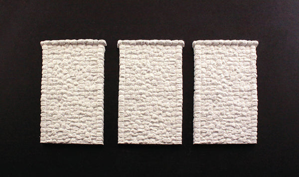 Woodland Scenics C1261 HO scale random-stone retaining walls, three unpainted wall sections.
