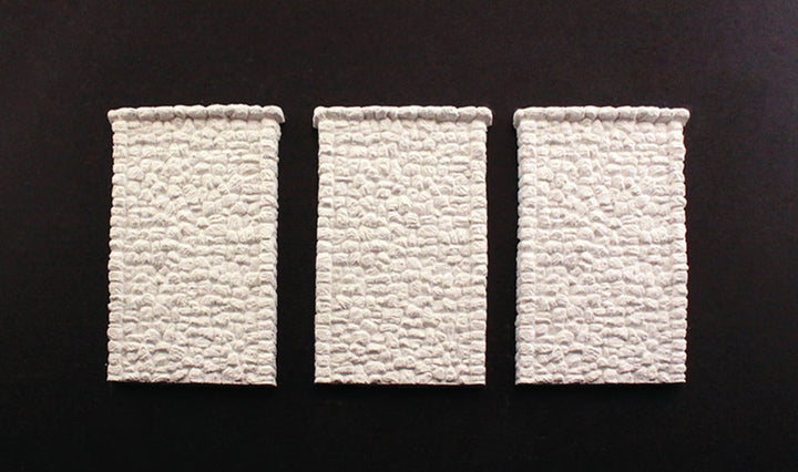 Woodland Scenics C1261 HO scale random-stone retaining walls, three unpainted wall sections.