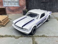 Side view of 1965 Mustang Fastback custom Hot Wheels with black-and-chrome wheels