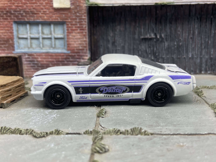 1965 Ford Mustang Fastback custom, Detroit white and blue, black wheels, view 1