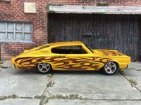 Yellow 1967 Dodge Charger custom Hot Wheels with flame graphics, view 1